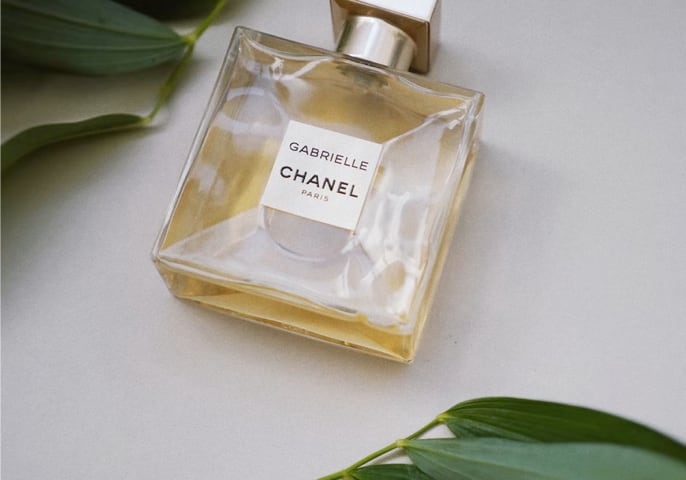 chanel perfume photo, white background with plants